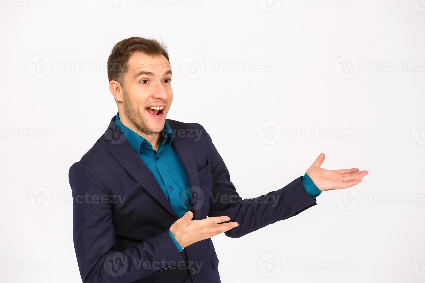 Man standing and presenting something above against white background photo