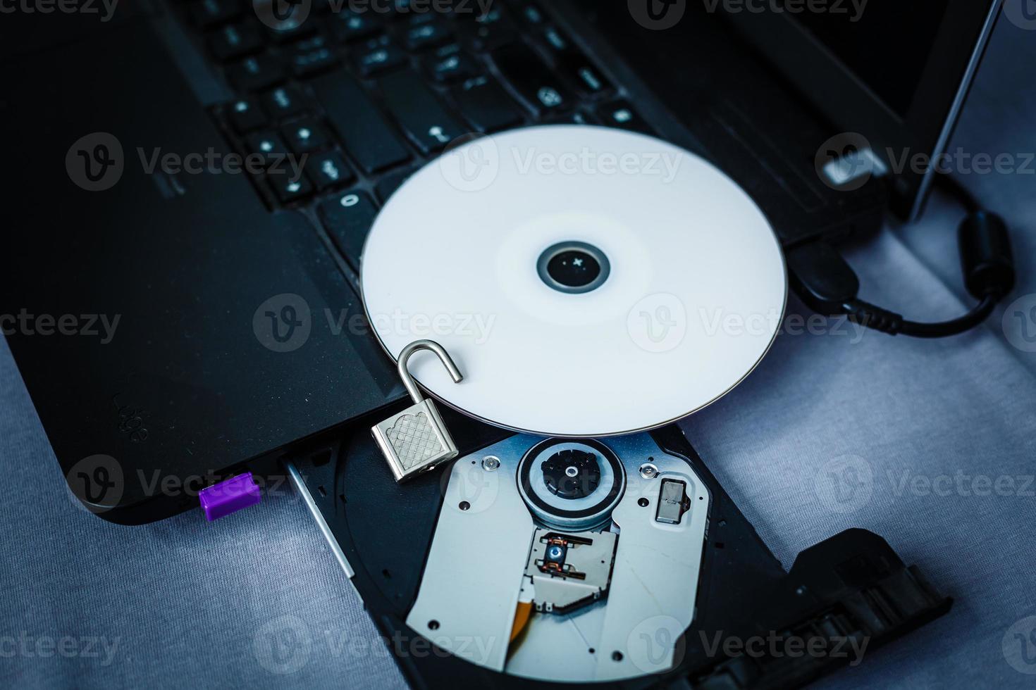 Danger CD in tray of computer laptop photo