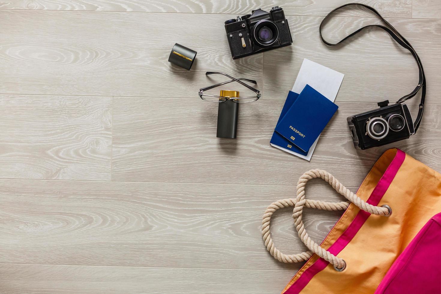 Flat lay traveler accessories on yellow background with palm leaf, camera and sunglasses. Top view travel or vacation concept. Summer background photo