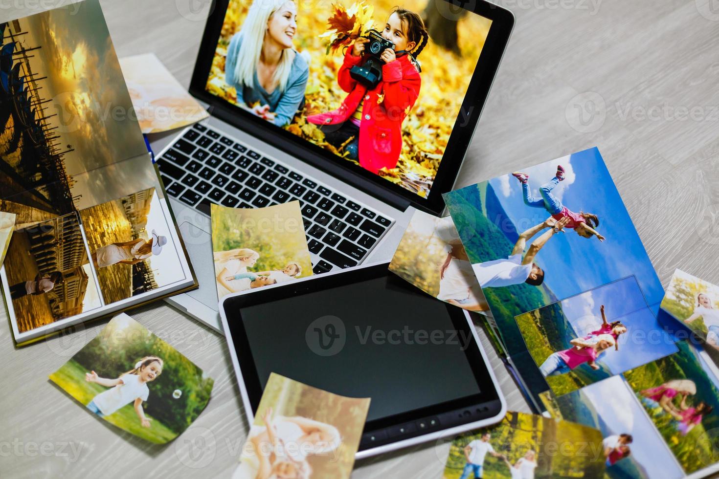 Old family photos on wooden background. Vintage pictures, notepad and modern notebook. Flat lay. Blank photo frames
