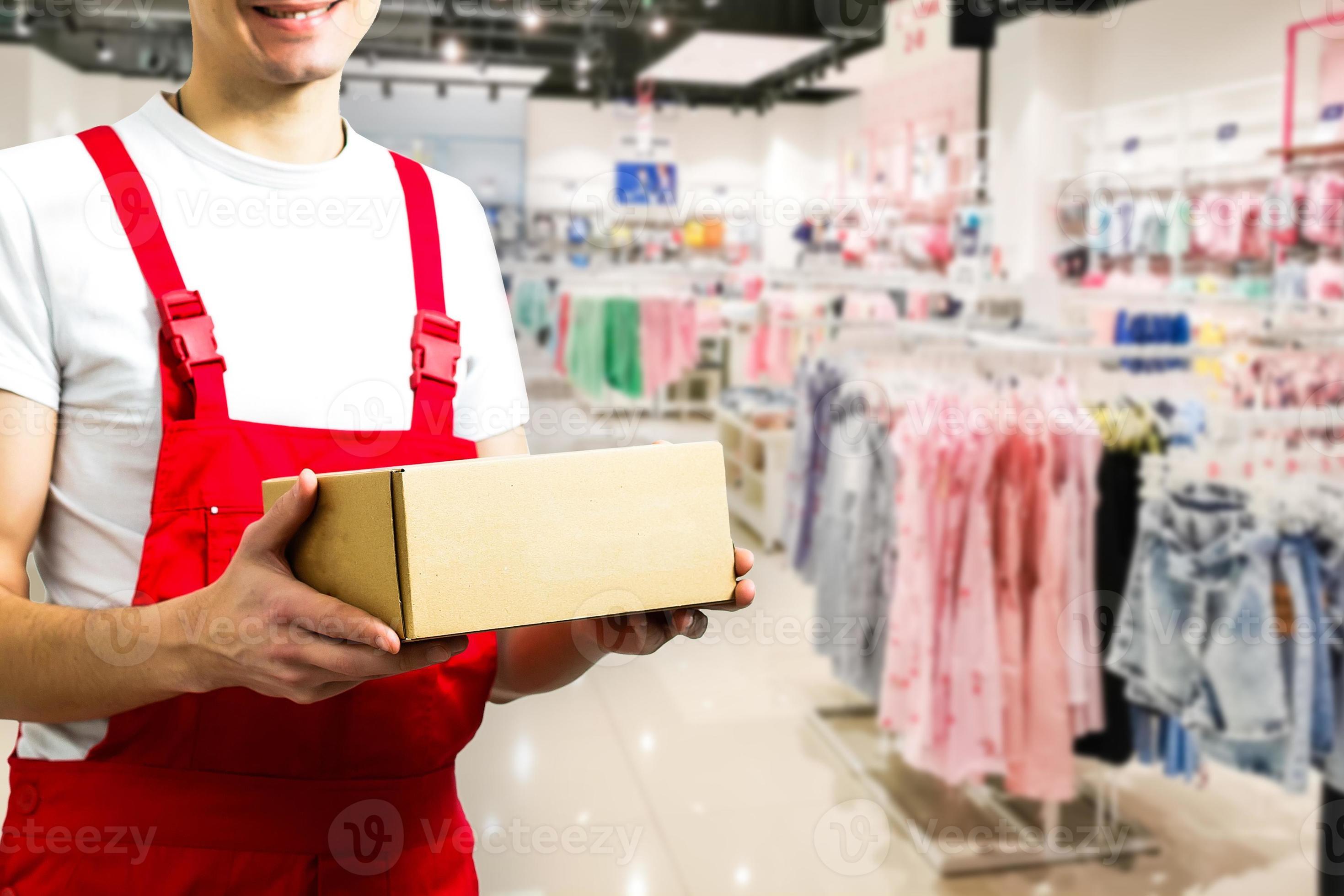 mage of a happy young delivery man in red delivery clothes 16476428