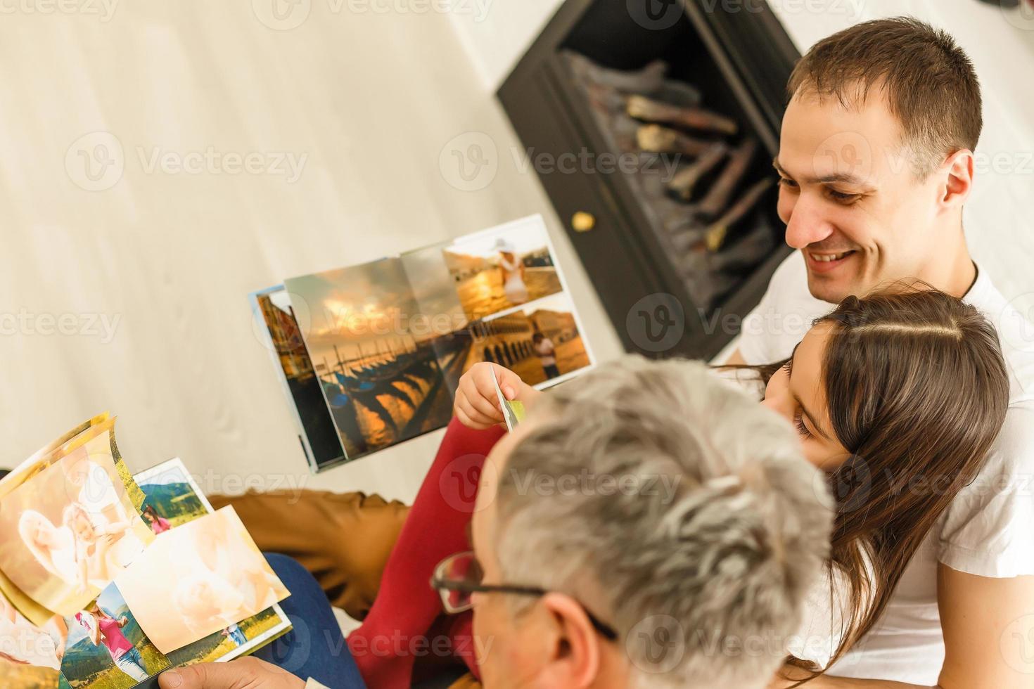 They look at family photo album in relative's house
