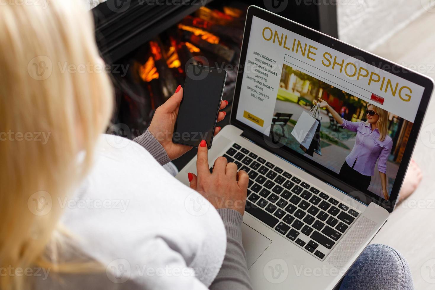 Online Shopping Concept. Back view of girl using laptop, looking at website, holding credit card, sitting at home photo