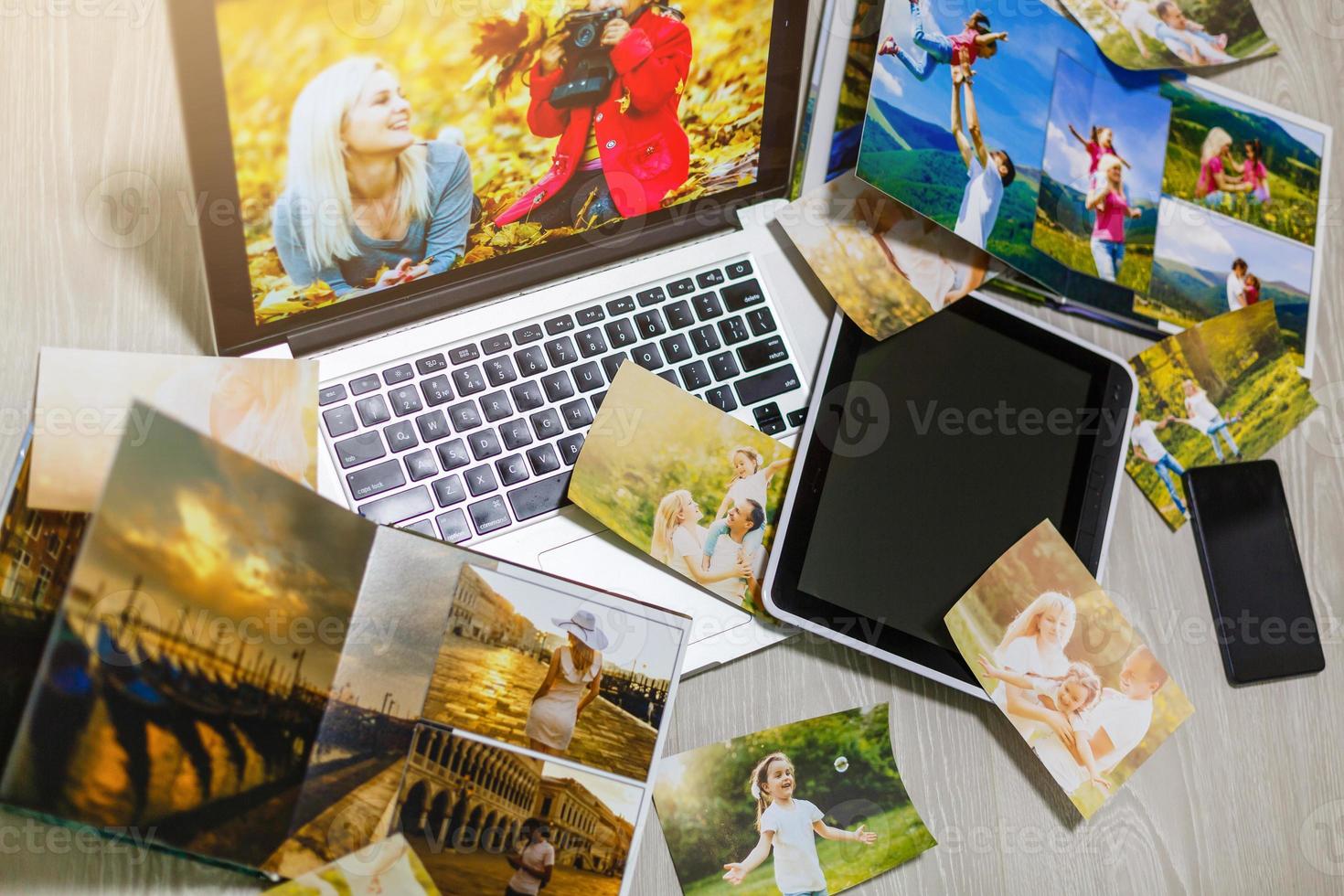 Old family photos on wooden background. Vintage pictures, notepad and modern notebook. Flat lay. Blank photo frames
