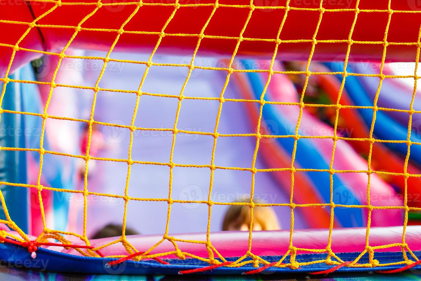 mesh on an inflatable trampoline. Active games for children photo