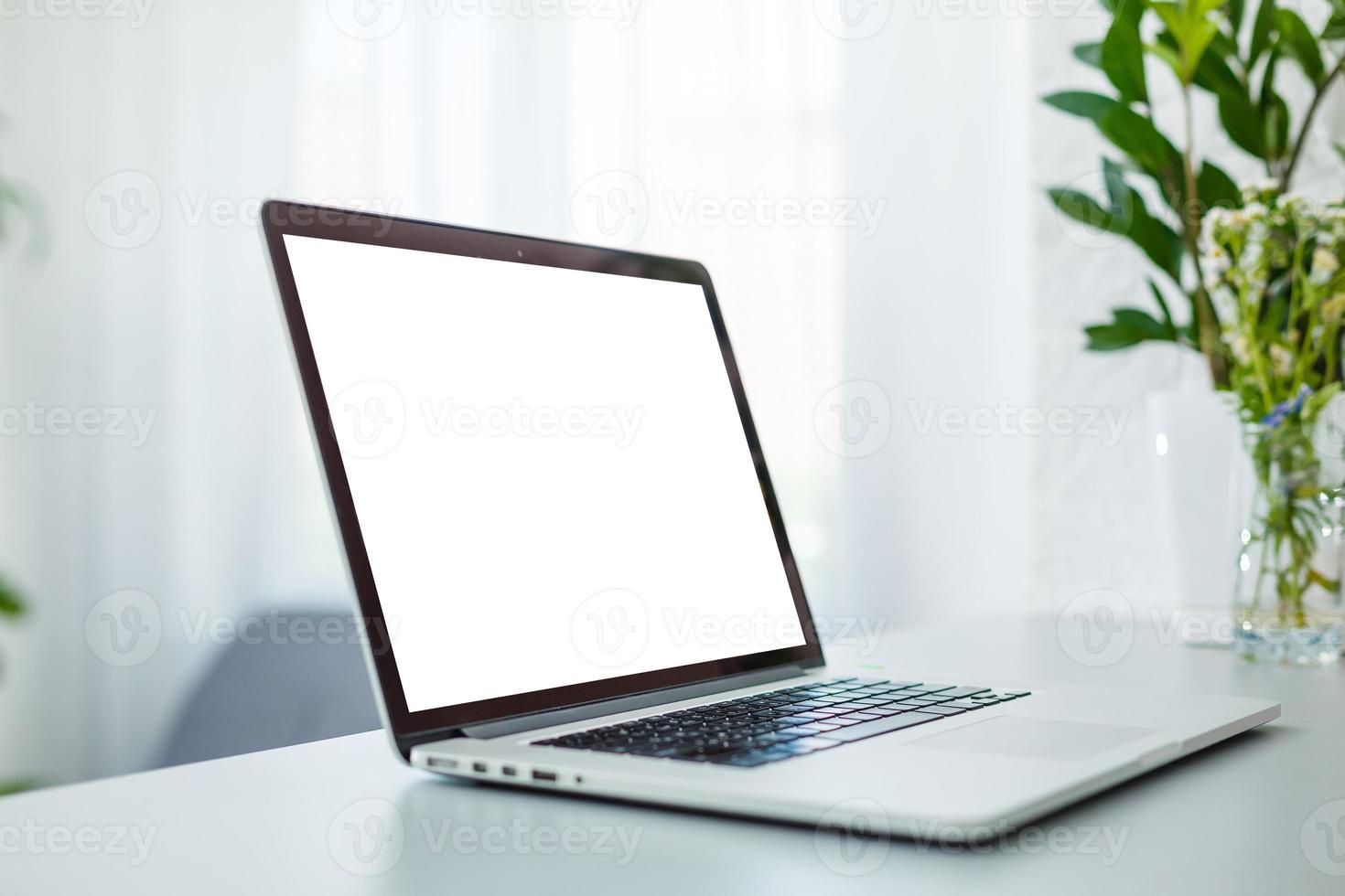 Kiev, Ukraine - june 18, 2019 Apple Macbook pro computer with dried flower vase and latte art coffee on wooden table, created by Apple Inc photo