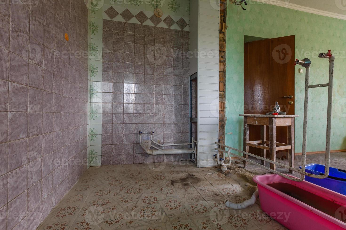 Devastated kitchen in a demolition house photo