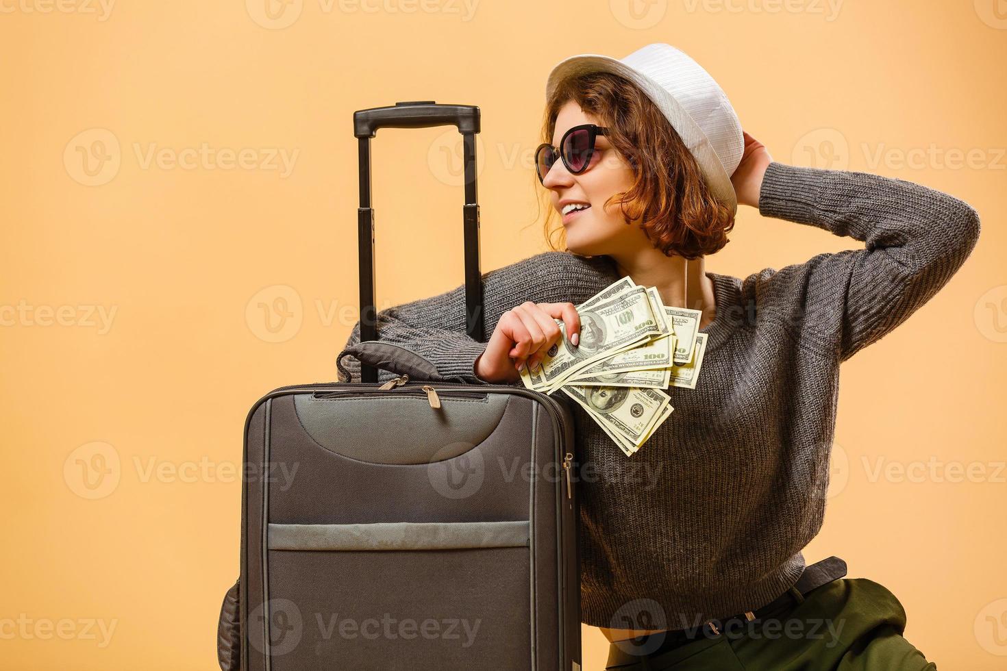 Close up tourist woman in summer casual clothes, hat at suitcase passport cash money isolated on yellow background. Passenger traveling abroad to travel on weekends getaway. Air flight concept photo