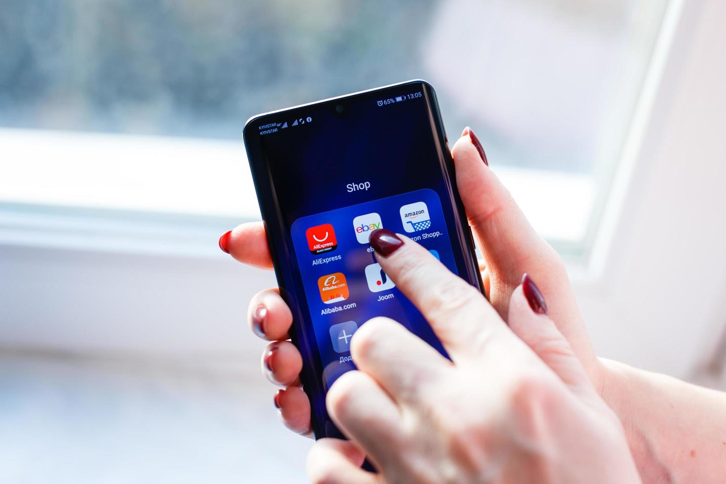eBay, Amazon, AliExpress and Alibaba apps icon on the screen smartphone. Closeup mobile applications for shopping, e-commerce. Kyiv, Ukraine - November 26, 2019 photo