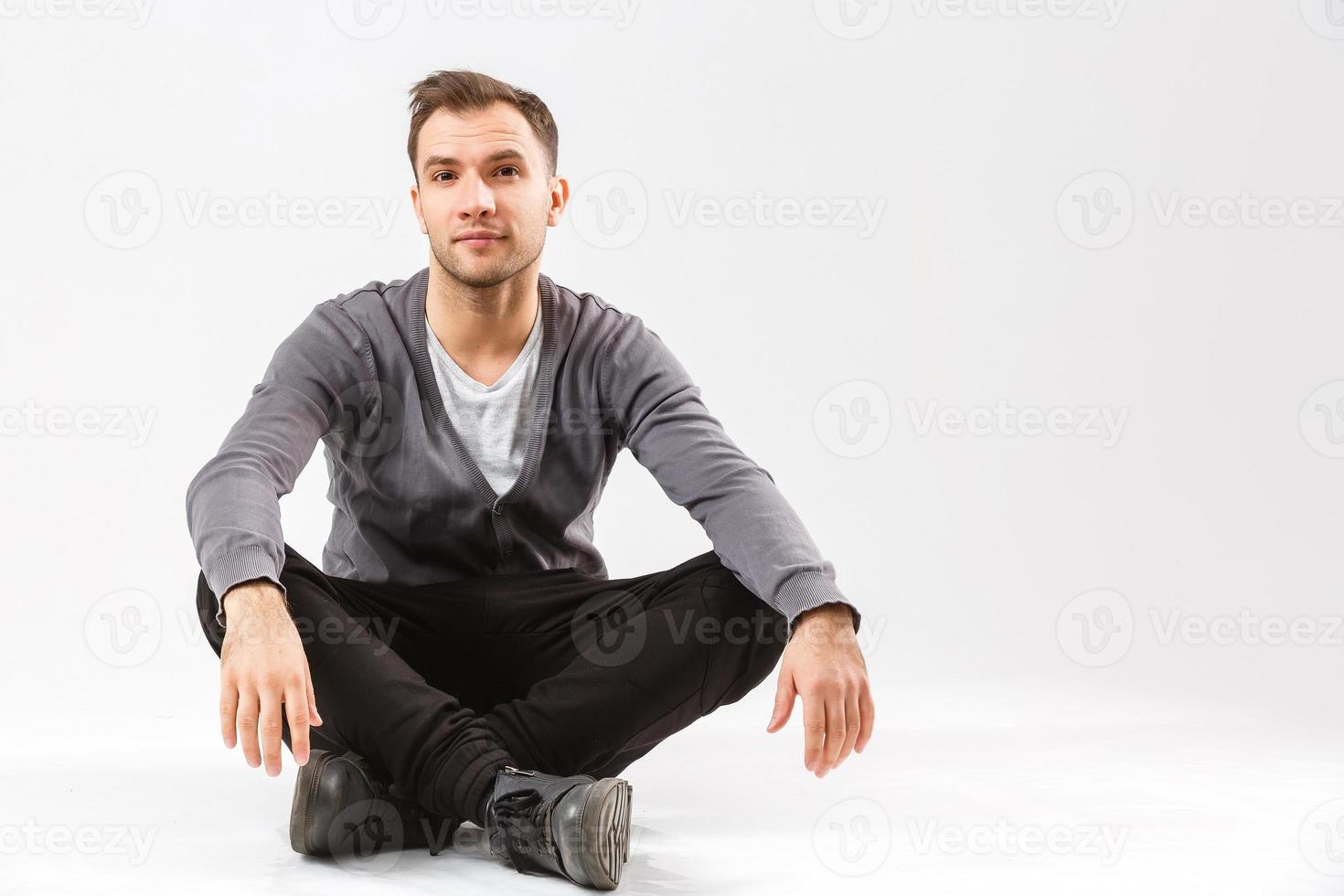 Flirtatious man sitting on the floor photo