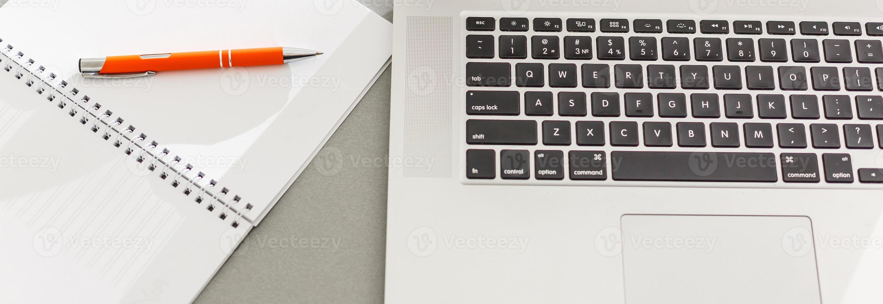 Notepad, laptop pen mouse and coffee cup on wood table in morning light.vintage effect photo