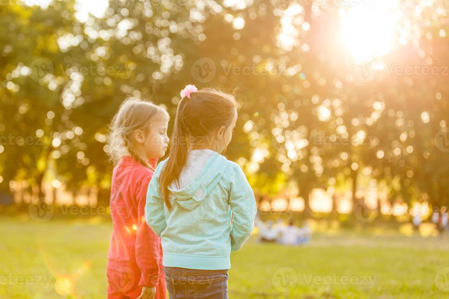two little girls walking in the field. photo