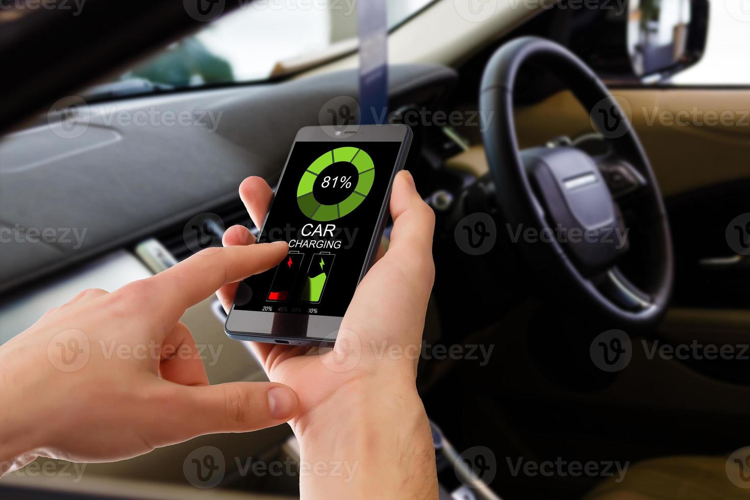 Charging Electric car Looking at App On Mobile Phone. Close up of smartphone screen. Hand holding smart device. Mobile application for eco transportation photo