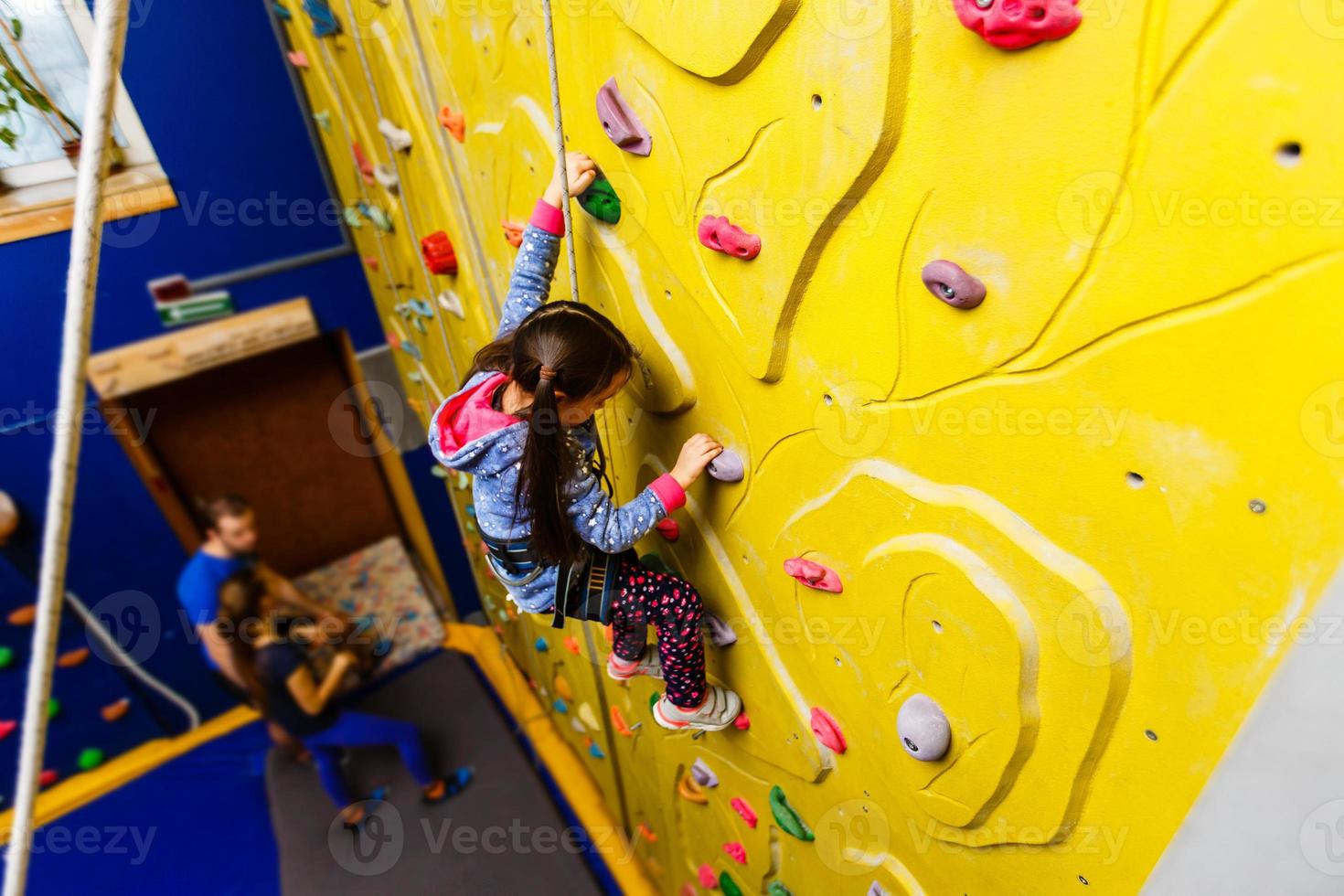 Little Girl Climbing Rock Wall photo