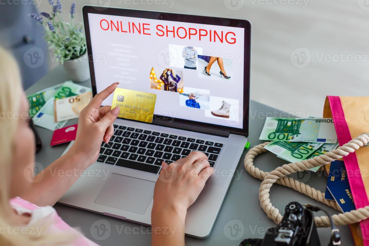 Close up of asian woman hands holding credit card and using laptop computer at coffee shop to perform shopping online by inputting card information for payment method. Ecommerce business concept. photo