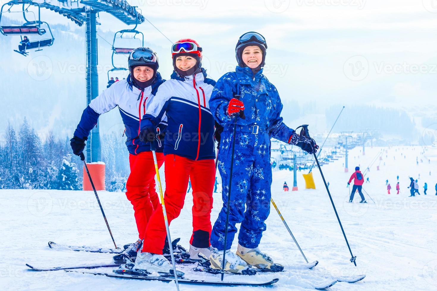 Group of friends with ski walking at a ski resort photo