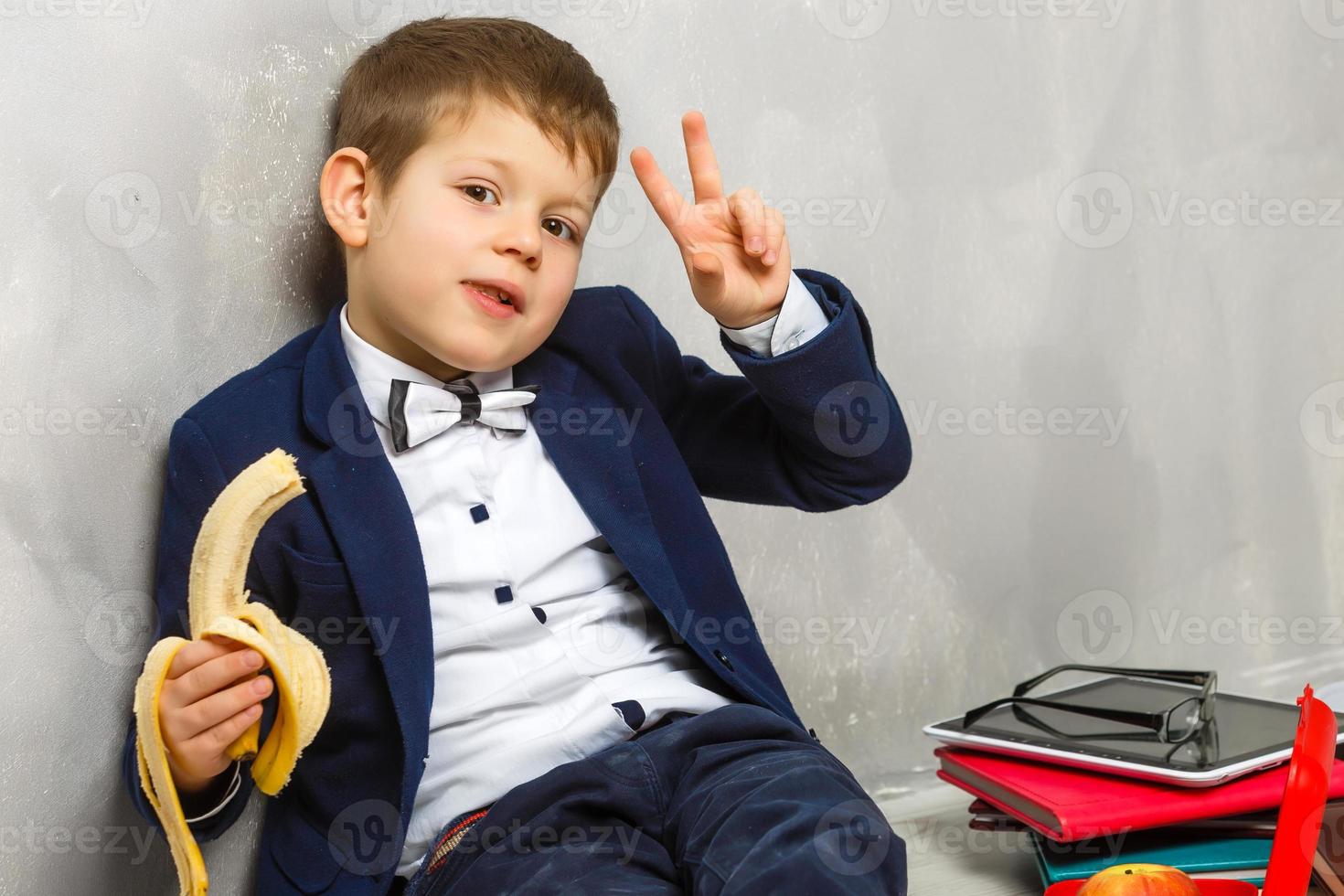 Schoolboy having a sandwich and an apple during his lunch break photo