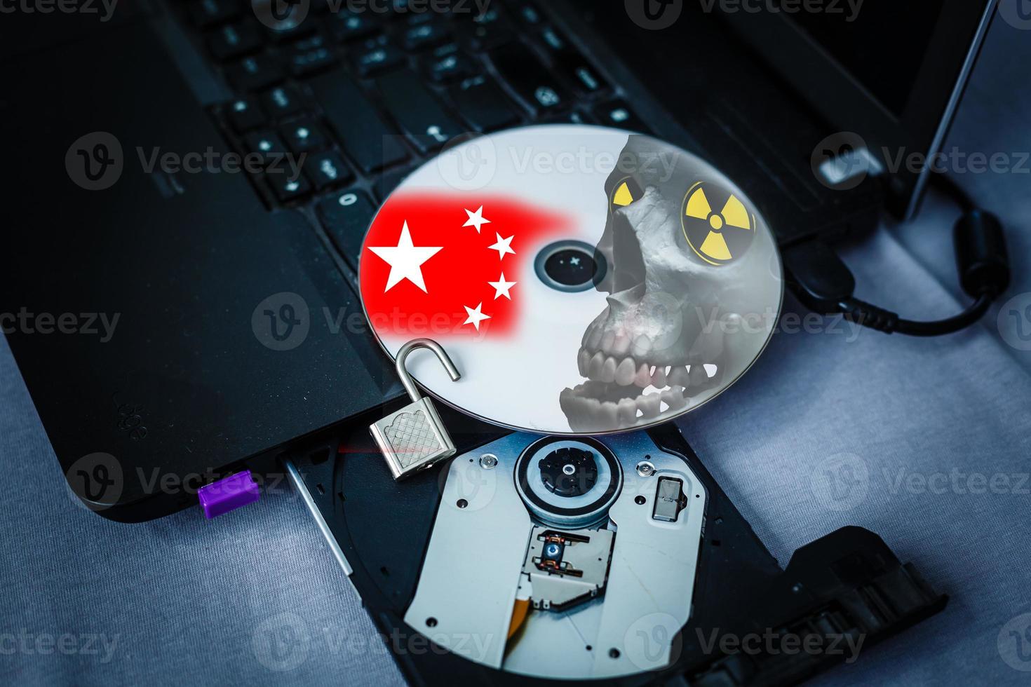 Danger CD in tray of computer laptop photo