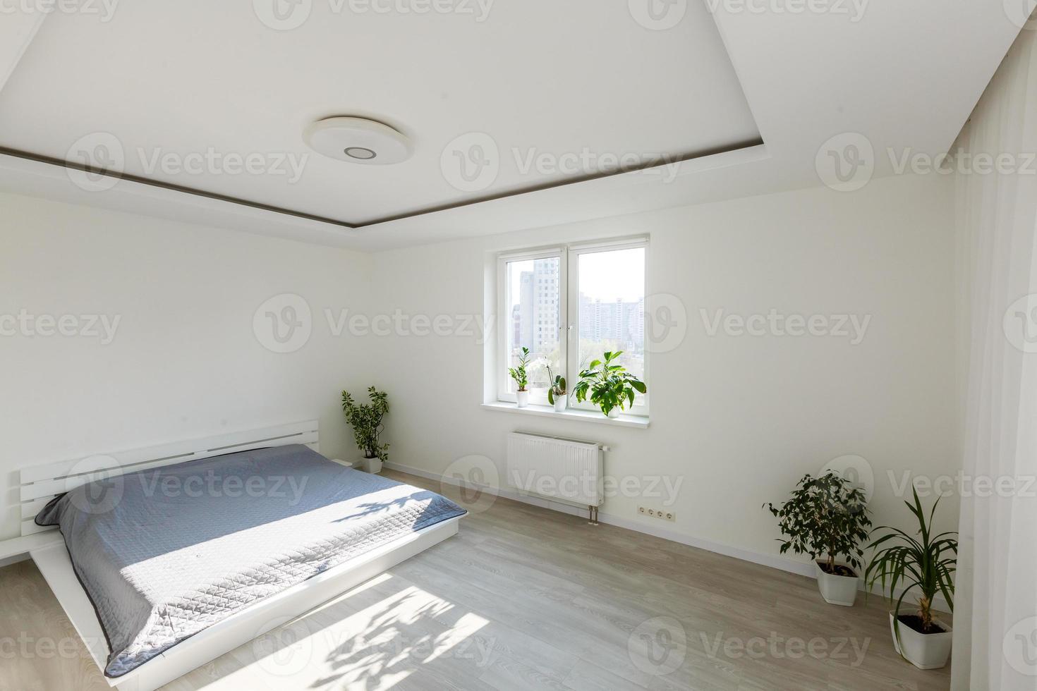 White bedroom with brick elements, balcony, double bed, desk photo