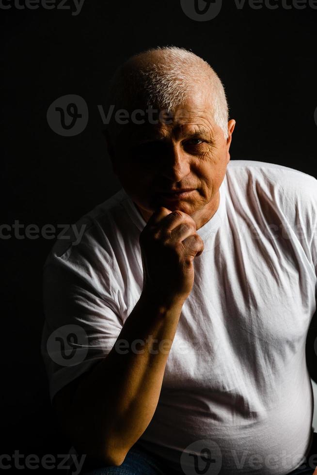 Old senior man closeup serious expression portrait photo