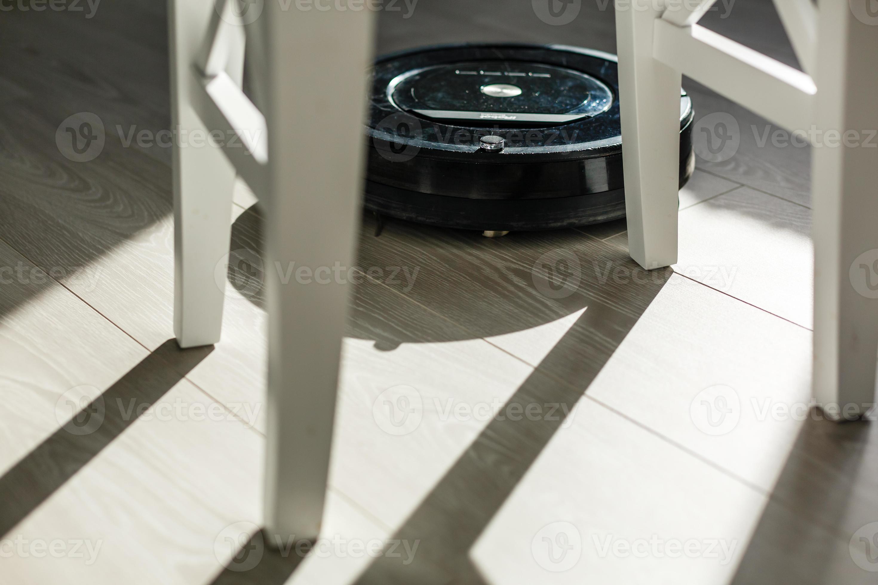 Robotic vacuum cleaner on laminate wood floor smart cleaning technology