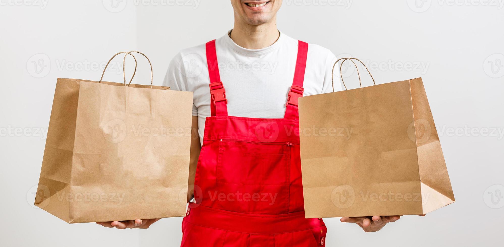 paper containers for takeaway food. Delivery man is carrying photo