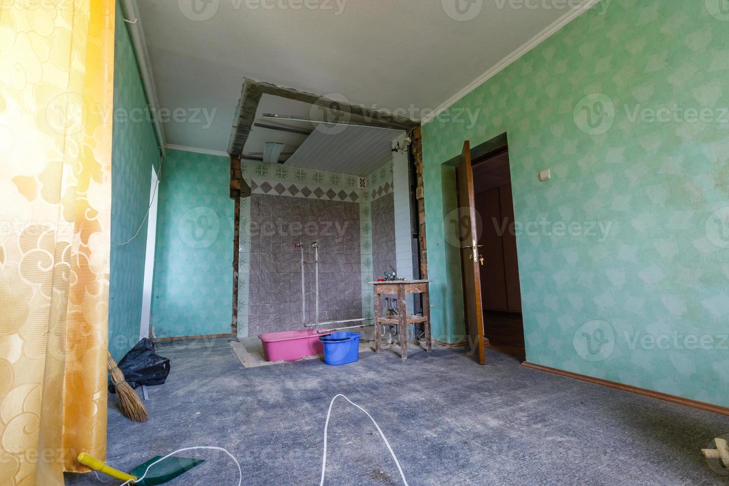 Devastated kitchen in a demolition house photo