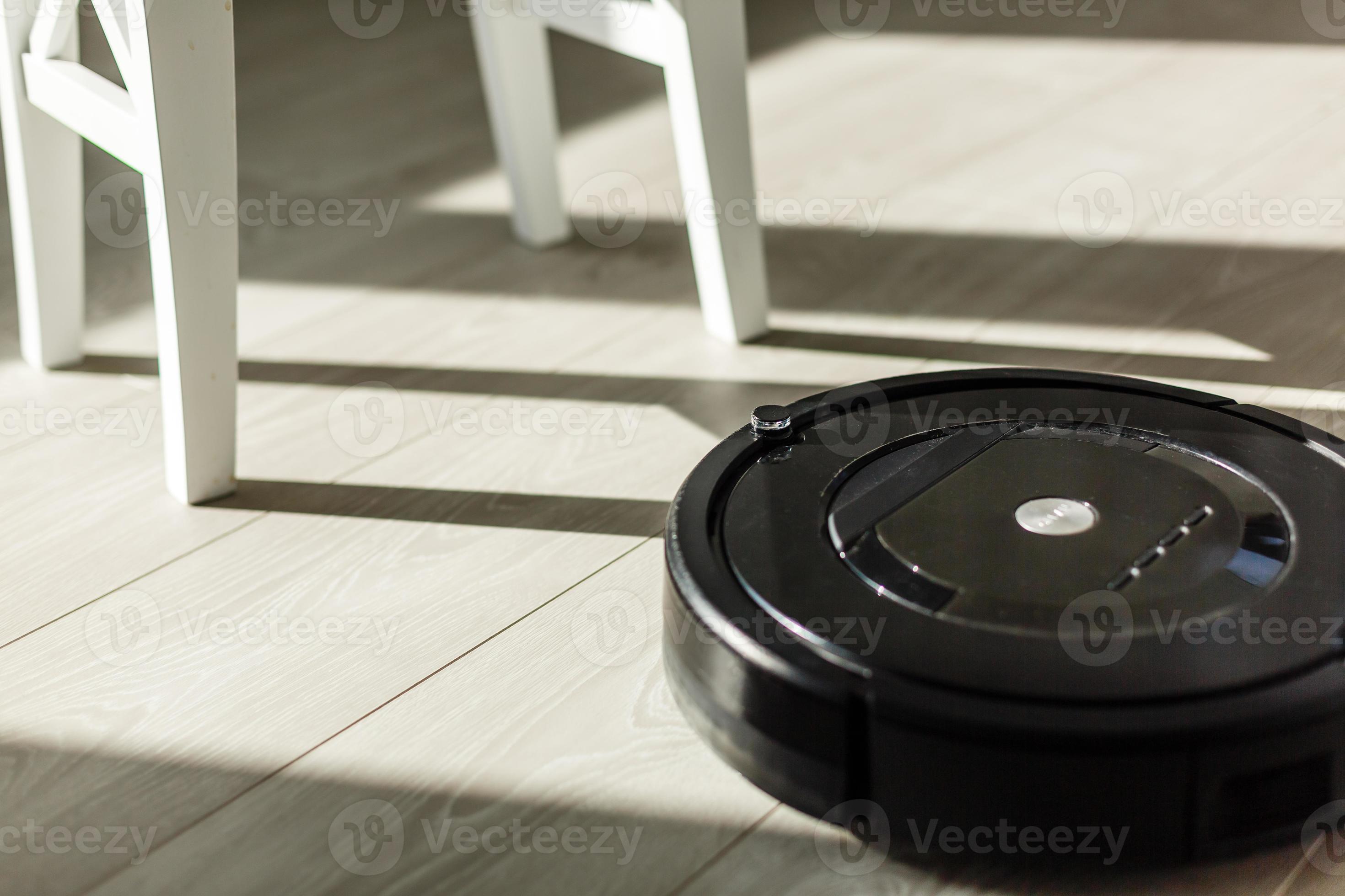 Robotic vacuum cleaner on laminate wood floor smart cleaning technology