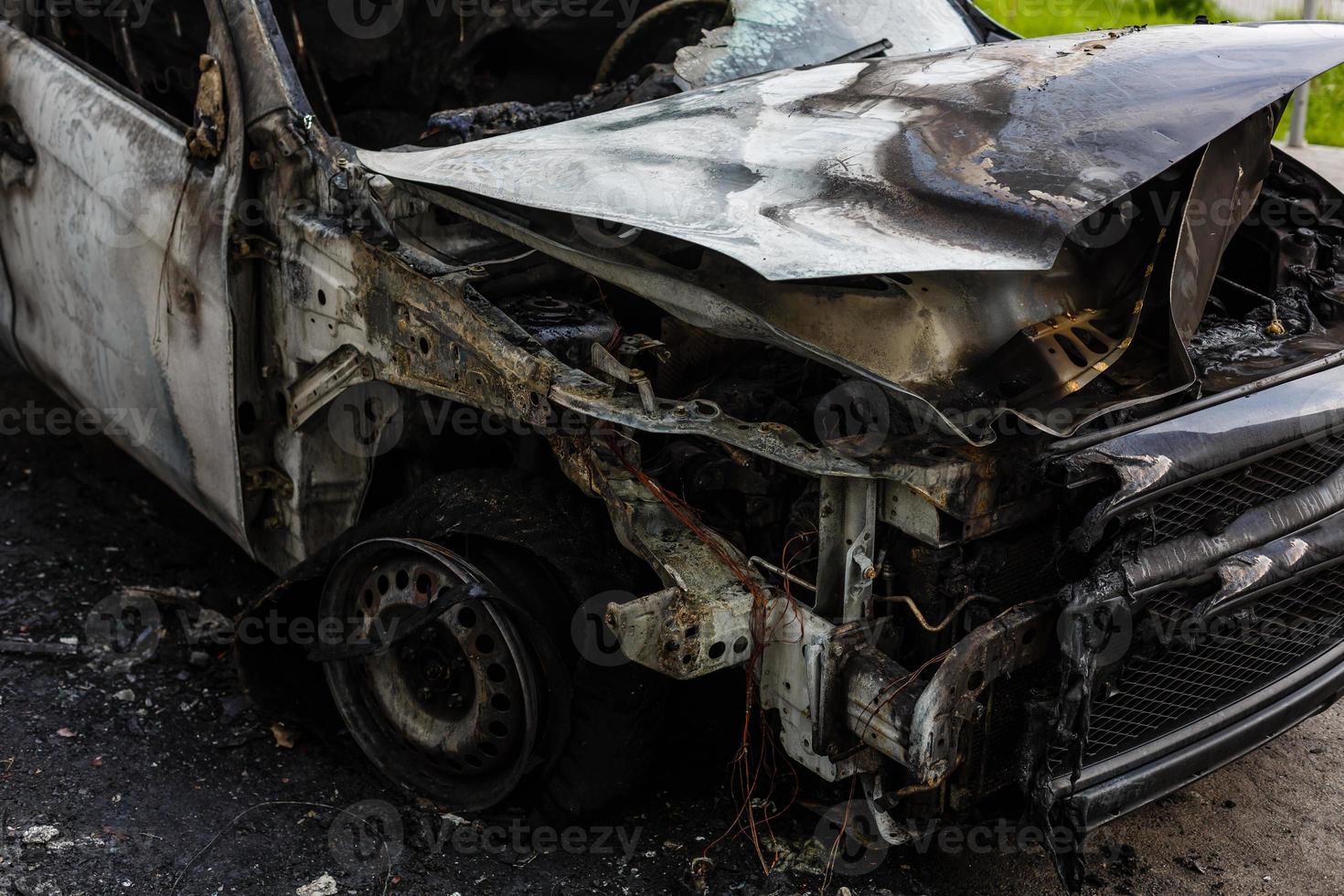 Two cars after the fire. Two burned out cars with an open hood. Arson, burnt car photo