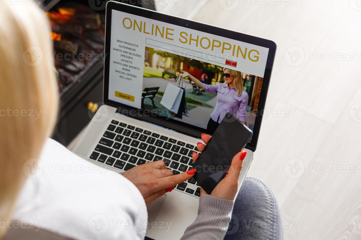 Online Shopping Concept. Back view of girl using laptop, looking at website, holding credit card, sitting at home photo