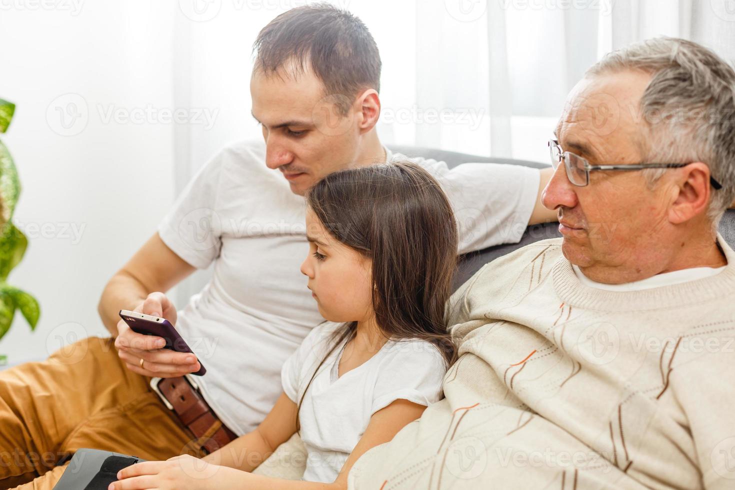 Big happy multigenerational family father, senior grandparents with cute little girl granddaughter at home. Family and love concept photo