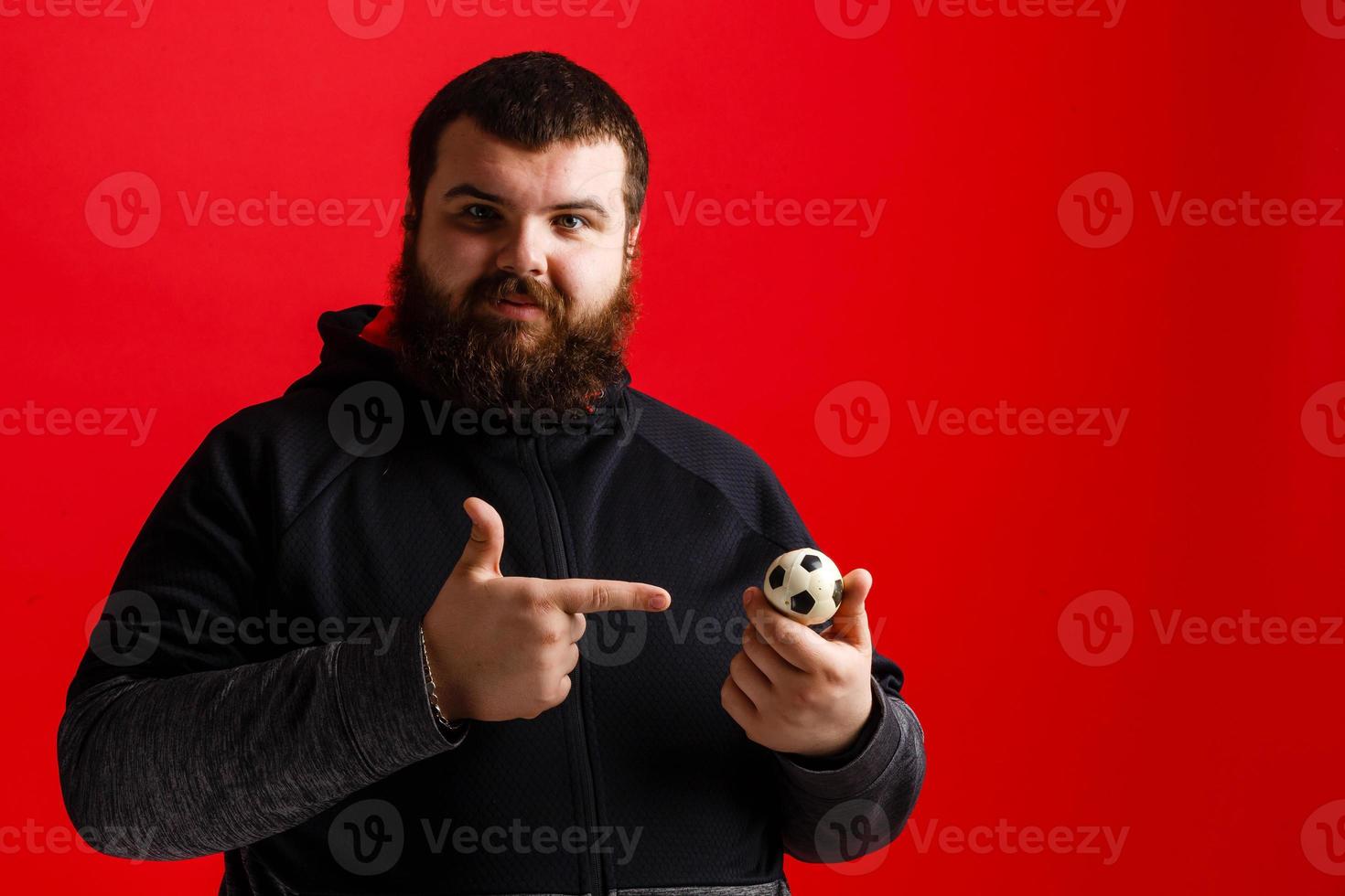 Happy young man holding a soccer ball photo