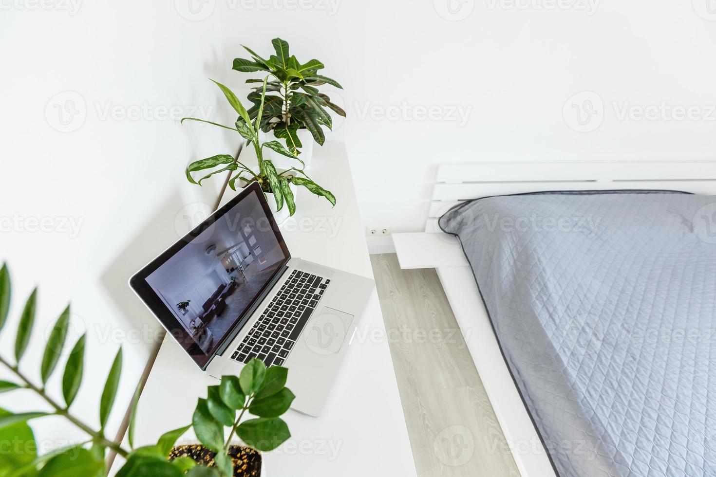 office tabletop with tablet, laptop showing cool hotel responsive design website photo
