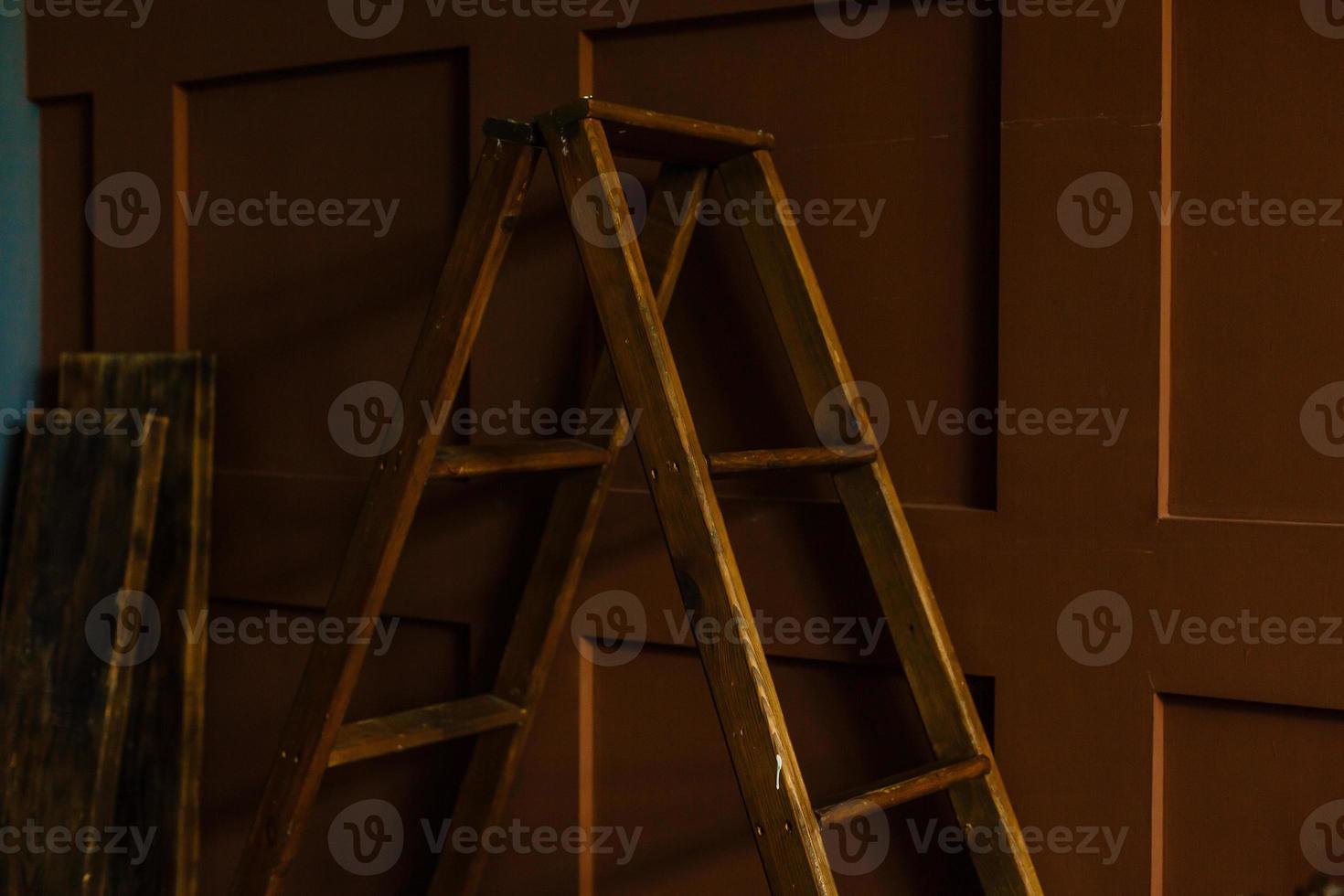 Old stepladder in an abandoned house. Repairs. photo