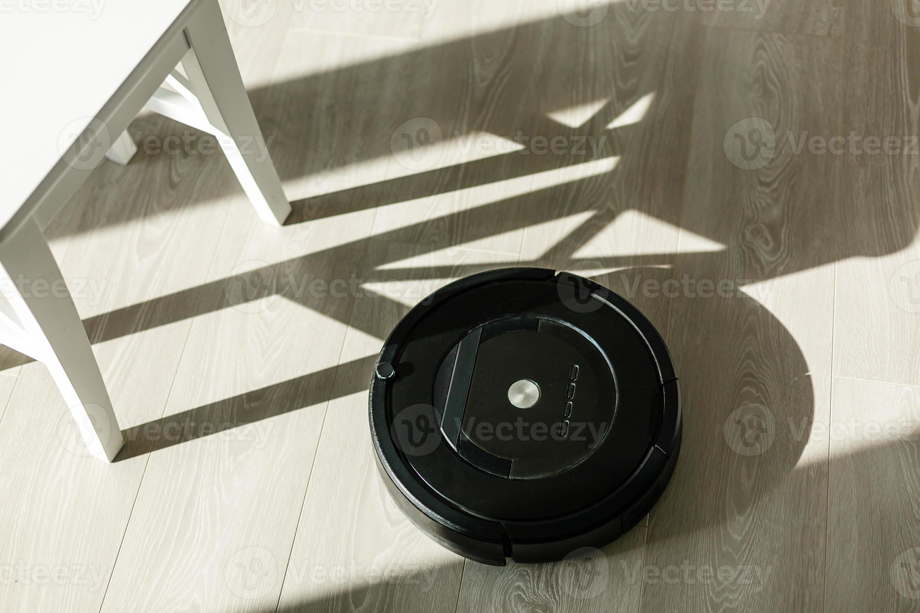 Robotic vacuum cleaner on laminate wood floor smart cleaning technology