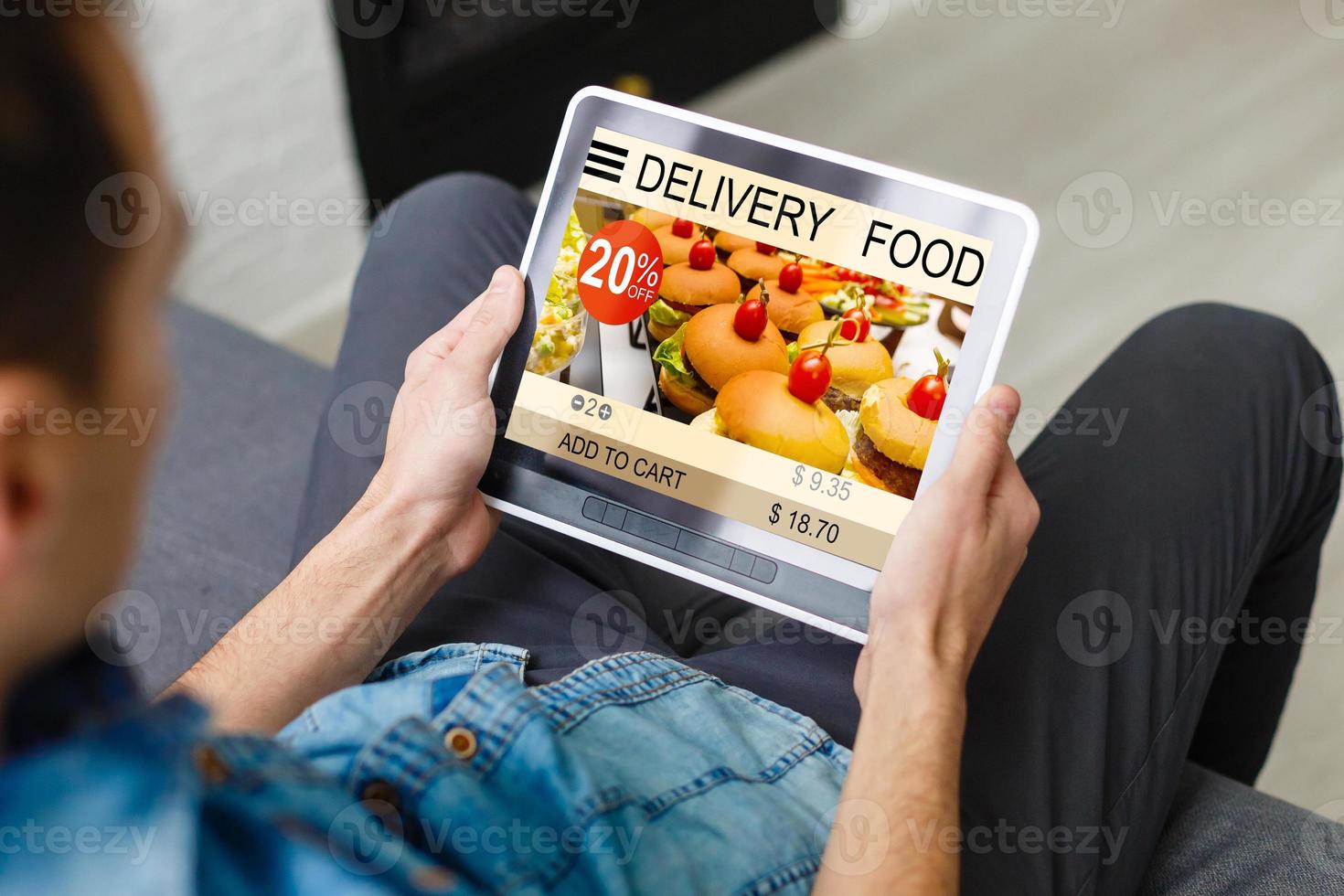Hipster man hands holding digital tablet with app delivery food screen photo