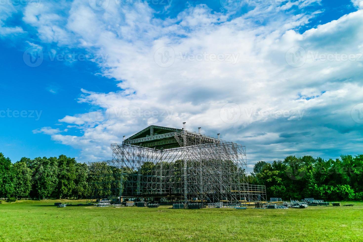 Assembling the big stage on grass of stadium photo