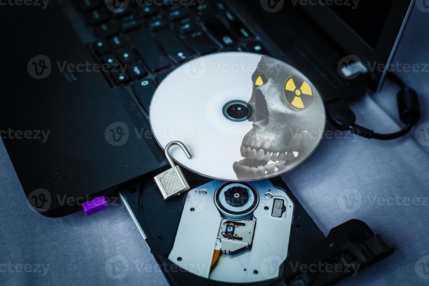 Danger CD in tray of computer laptop photo