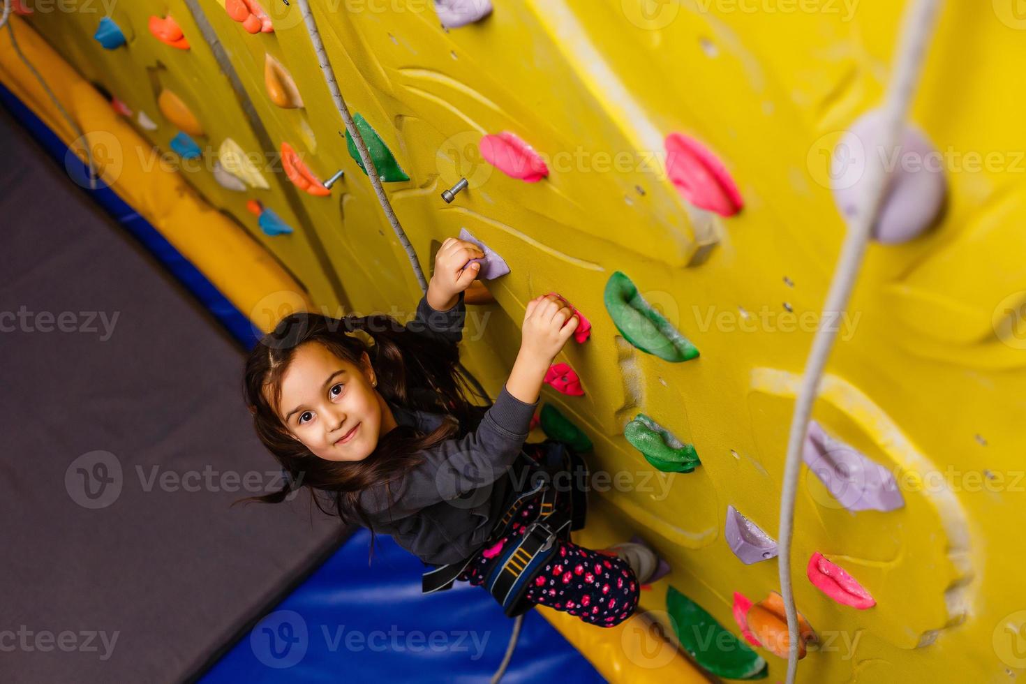 Little Girl Climbing Rock Wall photo