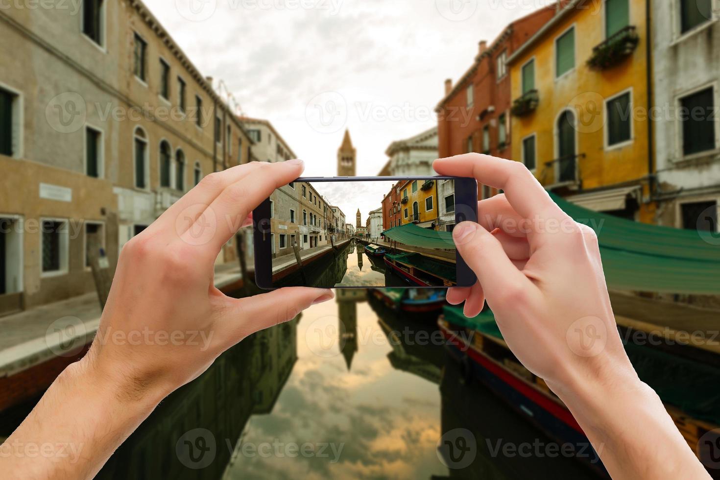 Traveler tourist taking beautiful landscape photo of european sunset during holiday vacation