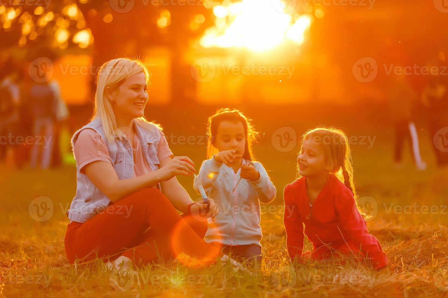 Two little girls are blowing soap bubbles, outdoor shoot photo