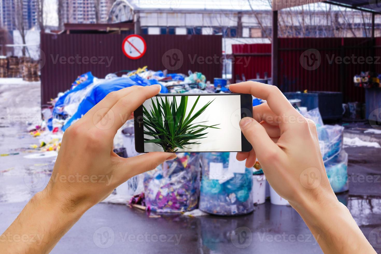 using touch screen mobile phone and Old factory garbage background photo