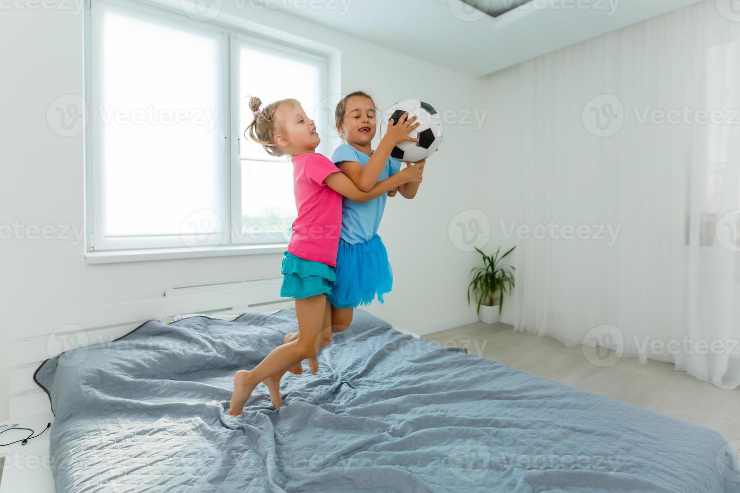 little girls with soccer ball at home photo