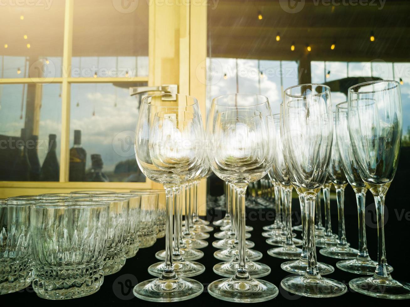 Wine glasses in row on bar photo