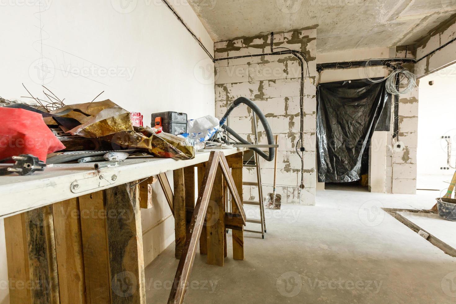 Renovation concept - ladder in empty apartment room during restoration or refurbishment photo