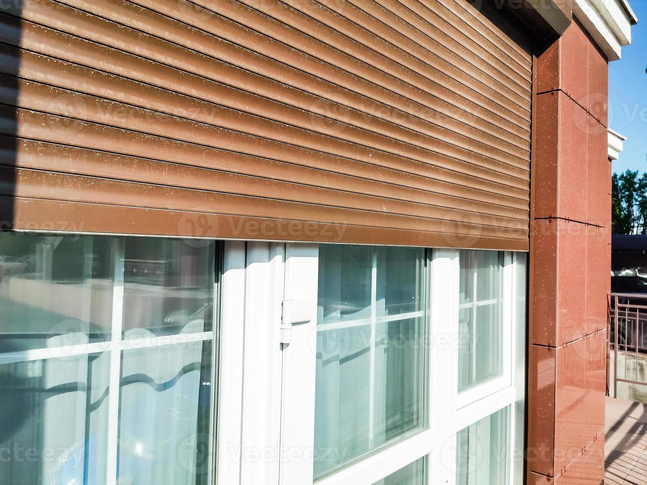 Window with modern shutter, exterior shot photo