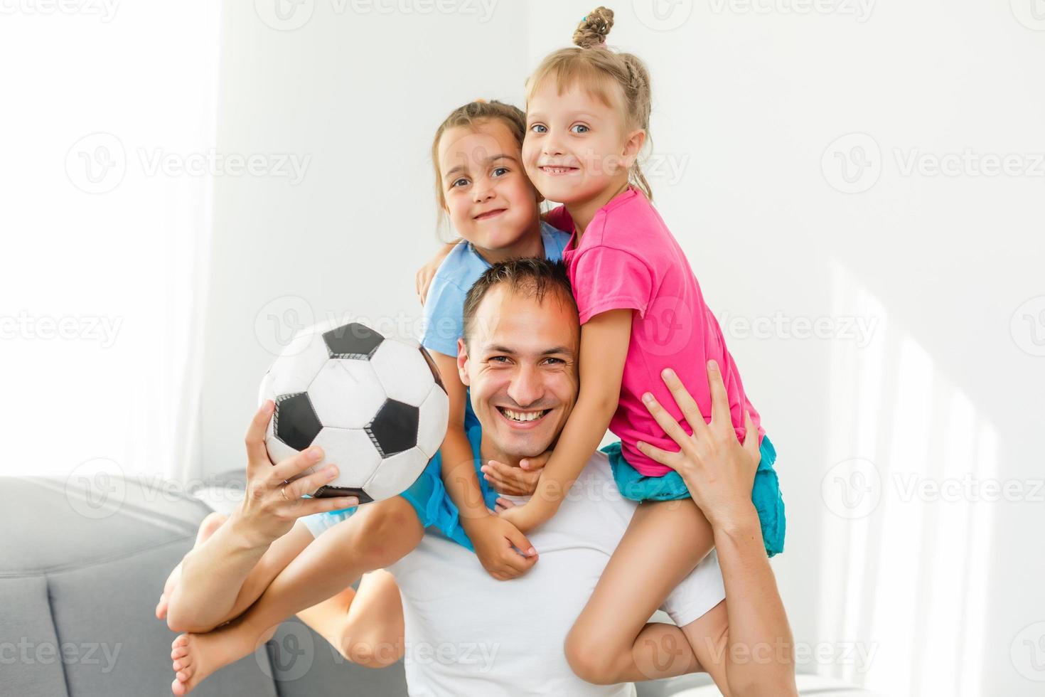 A family of fans watching a football match on TV at home photo