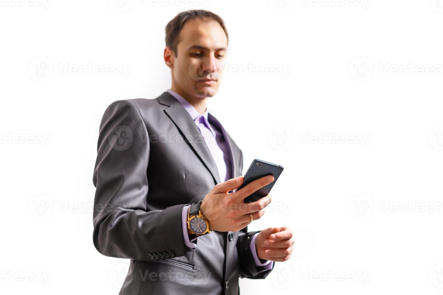 Happy businessman talking on the phone with folder in hand isolated over white background in studio shooting photo