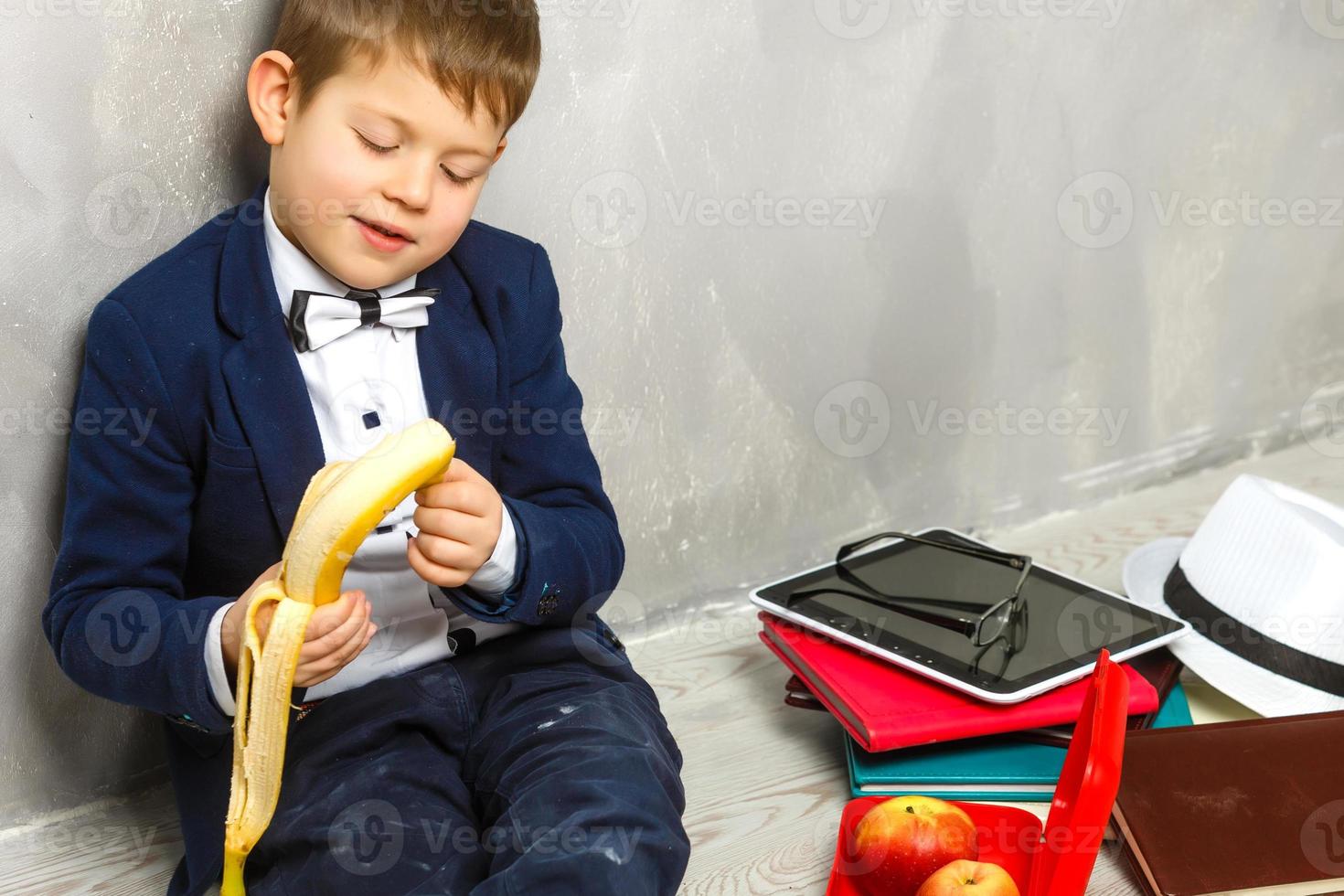 Schoolboy having a sandwich and an apple during his lunch break photo