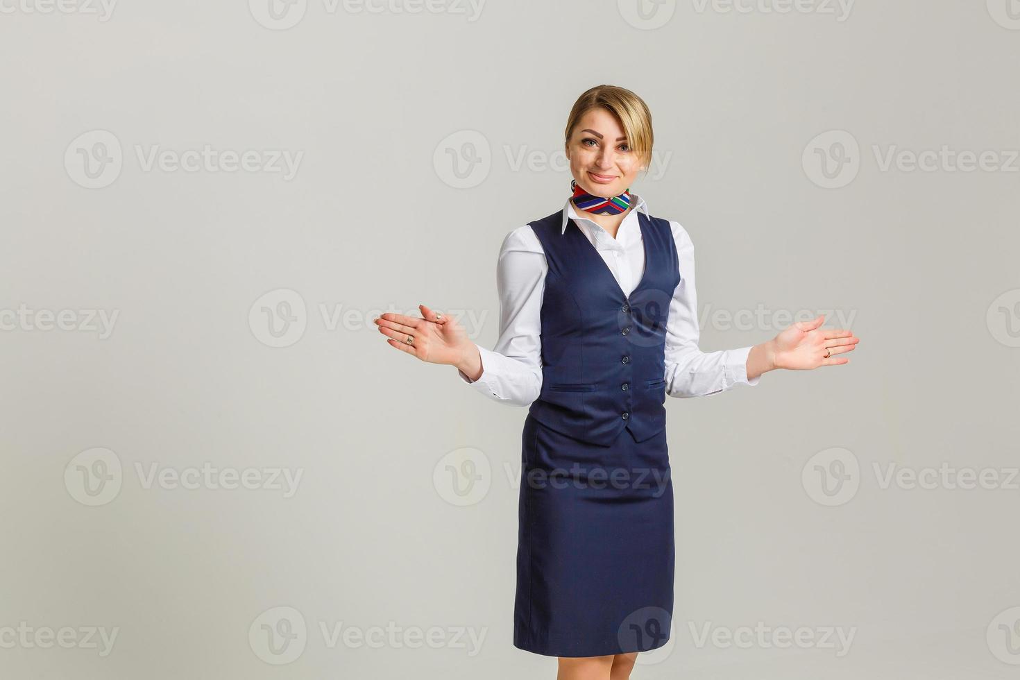 Portrait of charming stewardess wearing in blue uniform. Isolated on white background photo